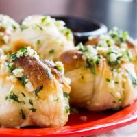 Homemade Garlic Knots · Our fresh pizza dough tied into knots tossed with fresh garlic, parsley and olive oil. Serve...