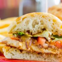 Grilled Tuscan Chicken Sandwich · Grilled chicken breast, grilled onions, sun-dried tomato and basil pesto, provolone and shav...