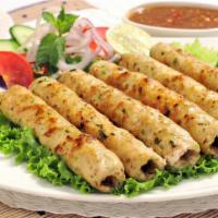 The Chicken Seekh Kebab · Exquisite grounded chicken seasoned with ginger, garlic, red onions and cilantro.