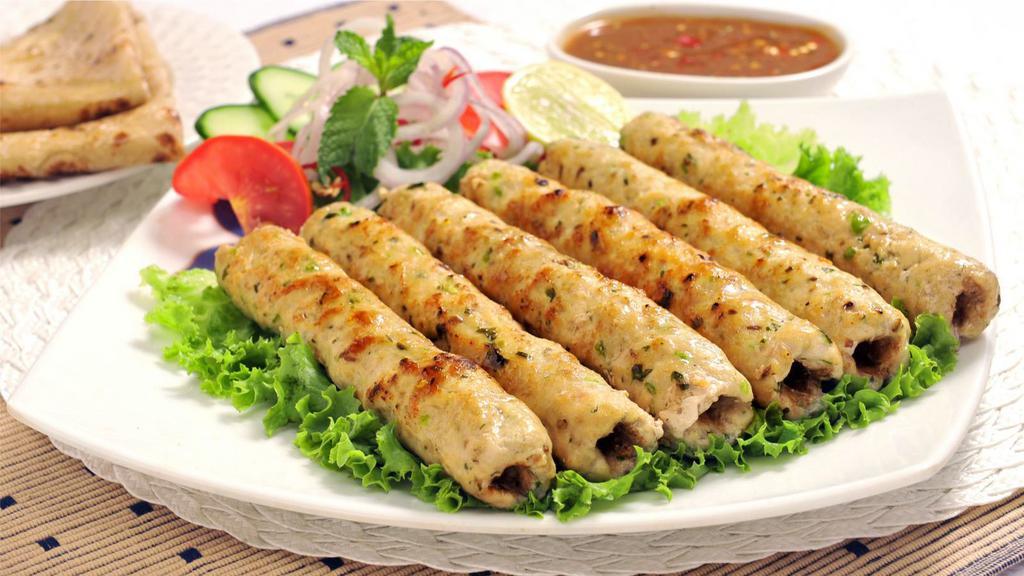 The Chicken Seekh Kebab · Exquisite grounded chicken seasoned with ginger, garlic, red onions and cilantro.