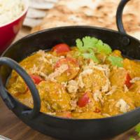 Lamb Karahi · Fresh cut lamb slowly cooked with diced tomatoes, onions, sliced bell peppers, topped with c...