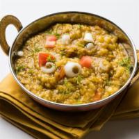 Baingan Bharta · Fresh eggplant mixed in with herbs, diced onions, peas, red tomatoes, and Indian spices. Ser...