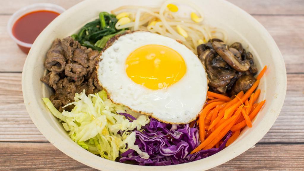 Bi Bim Bap · Steamed White Rice,  Carrots, Lettuce, Mushrooms, Spinach , Red Cabbage, Bean Sprouts, Beef Bulgogi, Sesame Oil and topped with Sunny Side Egg.