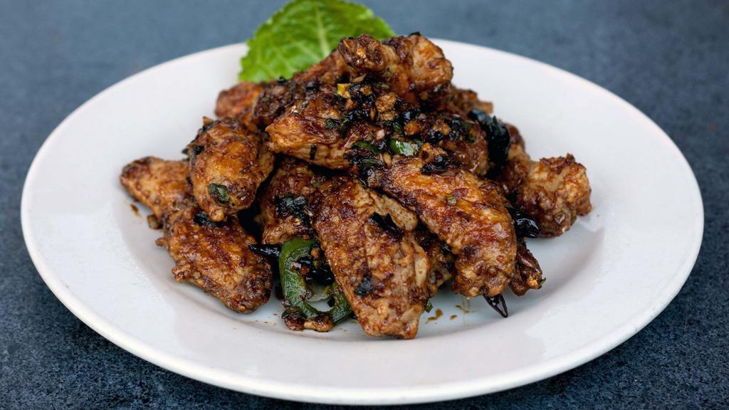 Mandarin Chicken Wings · Sauteed fried chicken wings with chili, garlic and onion in sweet soy sauce, in  Spicy level one.