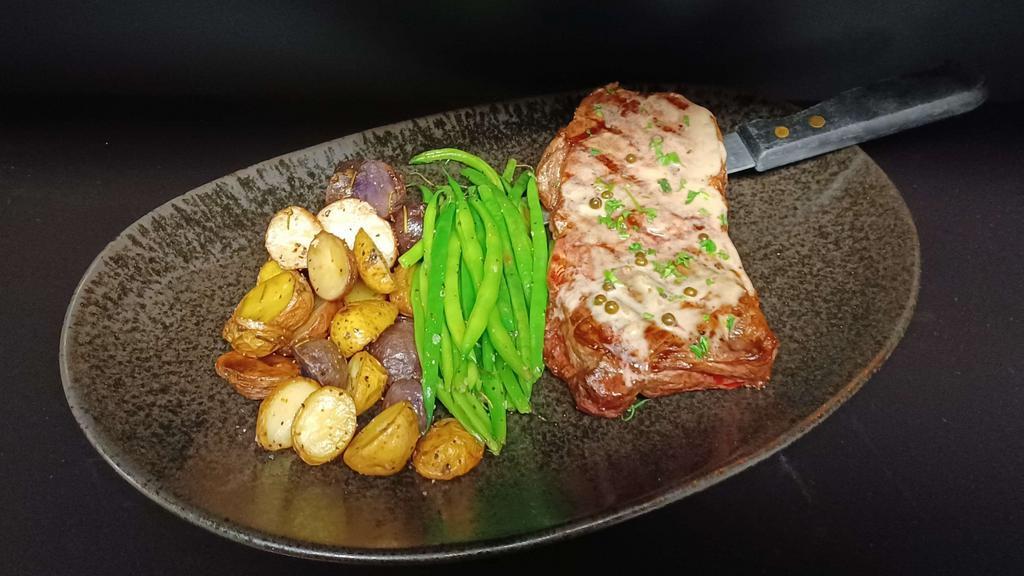 12-ounce N.Y. Steak · 12 ounce NY strip steak grilled to order, served with green beans, roasted baby potatoes and green peppercorn sauce.