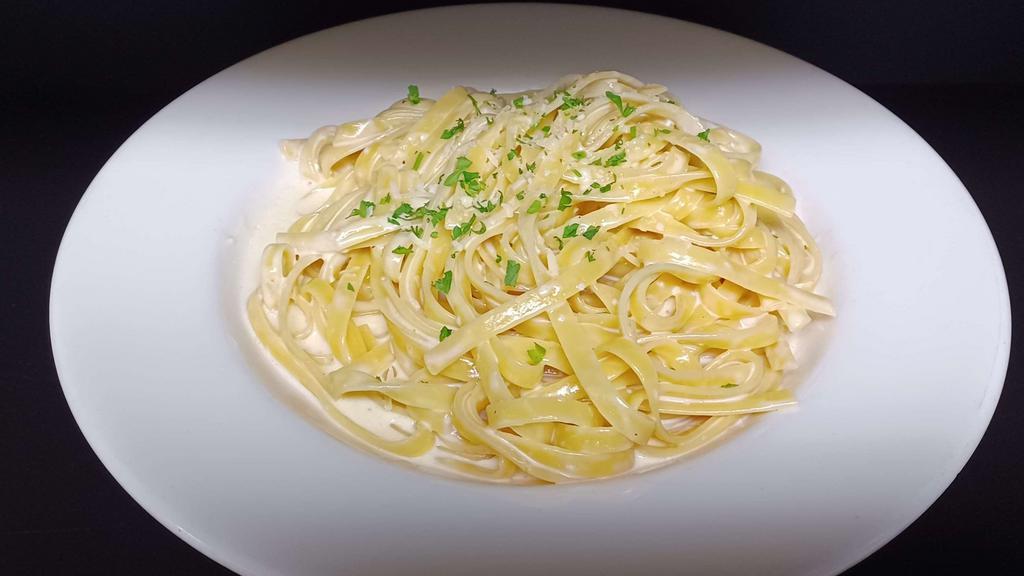 Fettucine Alfredo Pasta · Fettucine pasta tossed in a garlic cream sauce and parmesan cheese