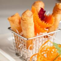 Crispy Spring Rolls · Vegetarian. Filled with shredded vegetables, silver noodles, and tofu. Served with sweet and...