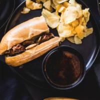French Dip · Roast Beef on a French roll with a side of au jus sauce.