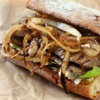 Steak Sandwich · New York steak, grilled onions, tomatoes, lettuce, and garlic mayonnaise on French roll.