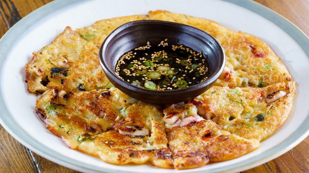 Seafood Pancake (해물전) · Traditional Korean style seafood (squid, mussel, and clam) pancake prepared with flour batter.
