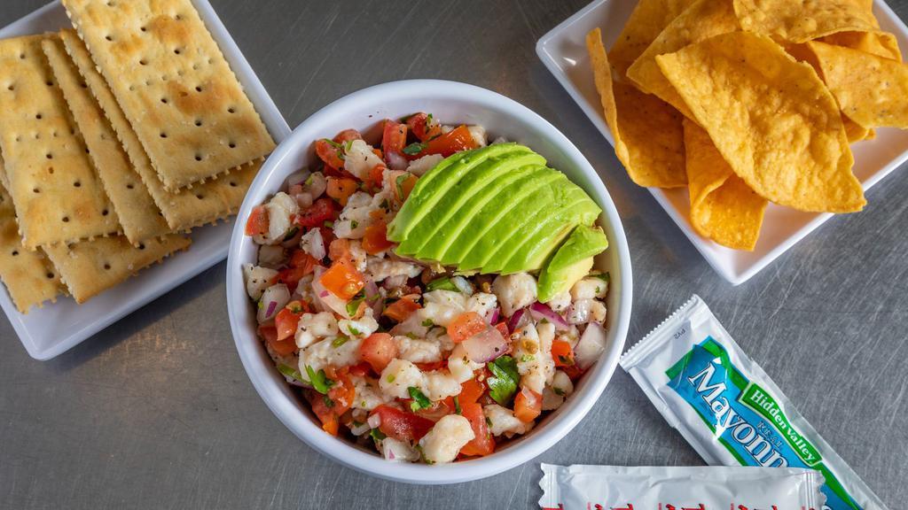 Ceviche · Flaky white fish cured in fresh lime juice with red onion, cilantro, tomato & serrano peppers.  Topped with slice avocado.  Made fresh to order.  

Served with Chips, Saltine Crackers & Mayo/Hot Sauce Packets