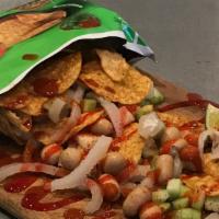 Tostilocos · Tostitos chips served with cueritos, cucumber, jicama, chamoy, lime, tajin, Japanese peanuts...