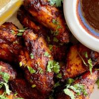New! BBQ Style Chicken Wings · Roasted in our brick ovens then tossed in our spicy, tangy bbq sauce. Served with your choic...