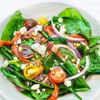 Spinach Salad · With roasted red peppers, red onion, tomato, bacon, crumbled Feta, toasted pine nuts. Served...