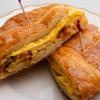 Breakfast Croissant · Egg, bacon and cheddar cheese on a croissant.