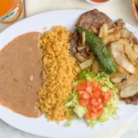 Carne Asada · Grilled steak with grilled onions on top. Served with beans, rice and tortillas