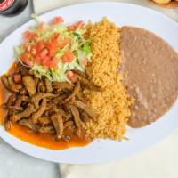Steak Ranchero · Juicy pieces of steak sautéed in red hot sauce. Served with beans, rice, and tortillas