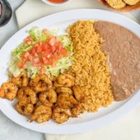 Camarones Toreados · Shrimped sautéed in butter, garlic, and chile arbol in olive oil. Served with beans, rice, a...