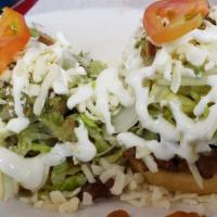 Sopes · Choice of meat, beans, lettuce, onion, tomato, cheese and sour cream.