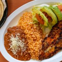 Filete De Pescado · Grilled fish, rice beans and salad.