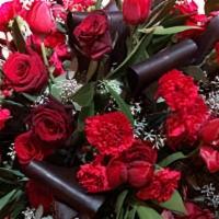 Rosie · Two dozen roses are designed within a keepsake vase.  These roses are upscale hybrid-tea ros...