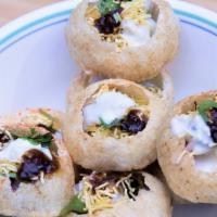 Dahi Batata Sev Puri · Crispy shells served with spiced potatoes mixture; topped with chutneys & yogurt.