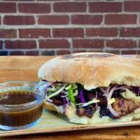 Martinez · braised beef brisket, queso oaxaca, red onion-cabbage slaw, jalapeño escabeche, served with ...