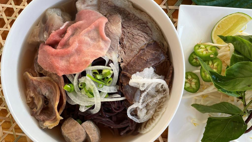 01. Forbidden Pho Combos · Forbidden black rice noodles with top of eye of round steak, well-done flank, well-done brisket, fat brisket, tendon, and tripe.