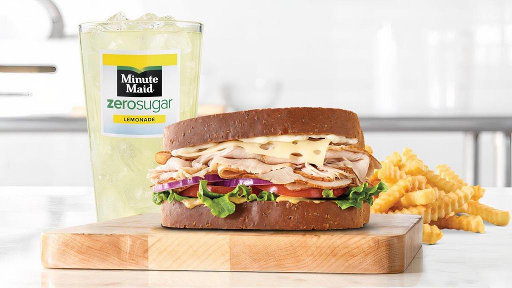 Roast Turkey & Swiss Sandwich · Sliced roast turkey with Swiss cheese, lettuce, tomato, red onion, spicy brown honey mustard and mayo on thick sliced honey wheat bread. Visit arbys.com for nutritional and allergen information.