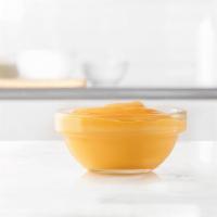 Cup Of Cheddar Sauce · A side of warm cheddar cheese sauce. Great for dipping.