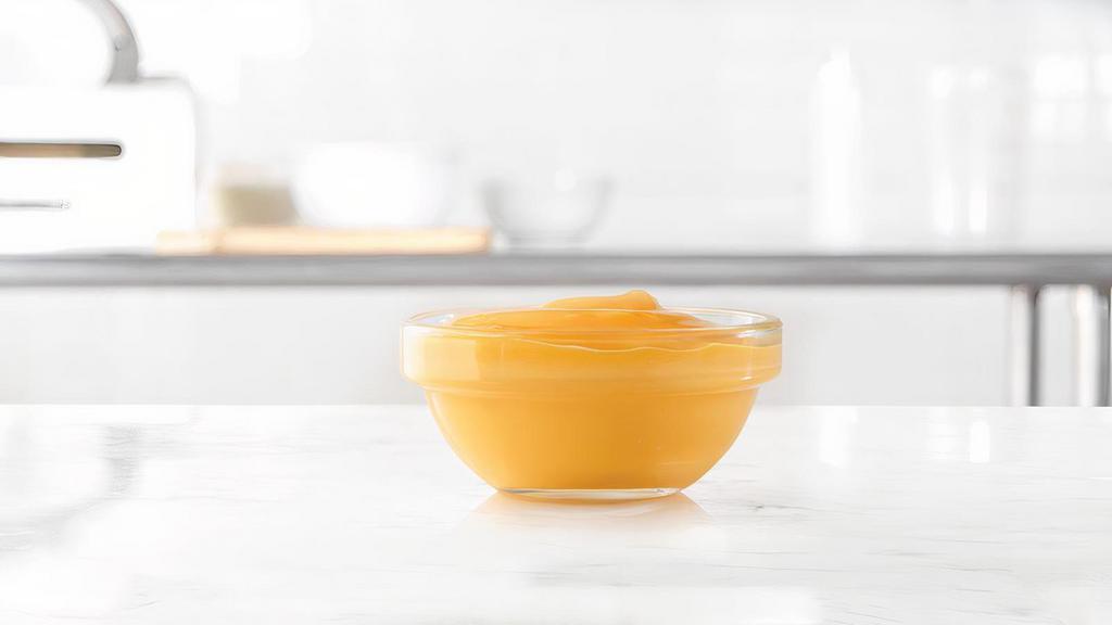 Cup Of Cheddar Sauce · A side of warm cheddar cheese sauce. Great for dipping.
