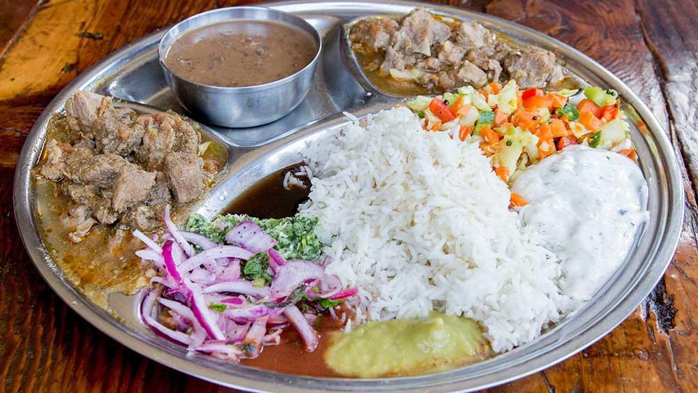 Thali Plate · Comes with your choice of two entrees and includes rice, daal (lentils), chutneys, marinated onions, and cucumber raita. **not available for reusable container