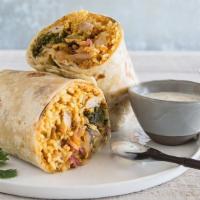 Super Kati Roll · A tasty Indian burrito. Choice of filling with chutney, onions, and basmati rice. Topped wit...