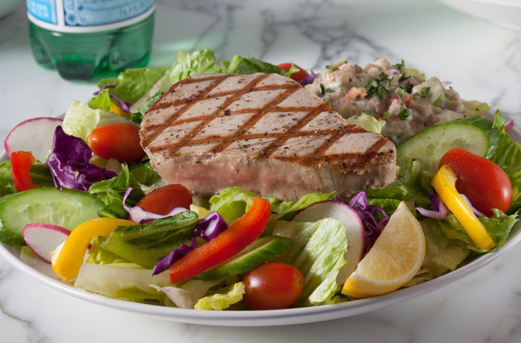 Grilled Ahi Tuna Kabob Salad (Gluten-Free) · Gluten-free. Fresh seasonal greens, bell peppers, cherry tomatoes, shredded cabbage topped with ahi tuna skewer, hummus, and lemon vinaigrette.
