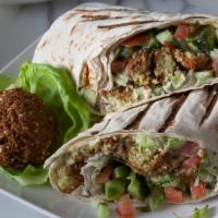 Falafel (Vegan) · Vegan. Fried chickpea patties with hummus and mediterranean salad topped with tahini wrapped...