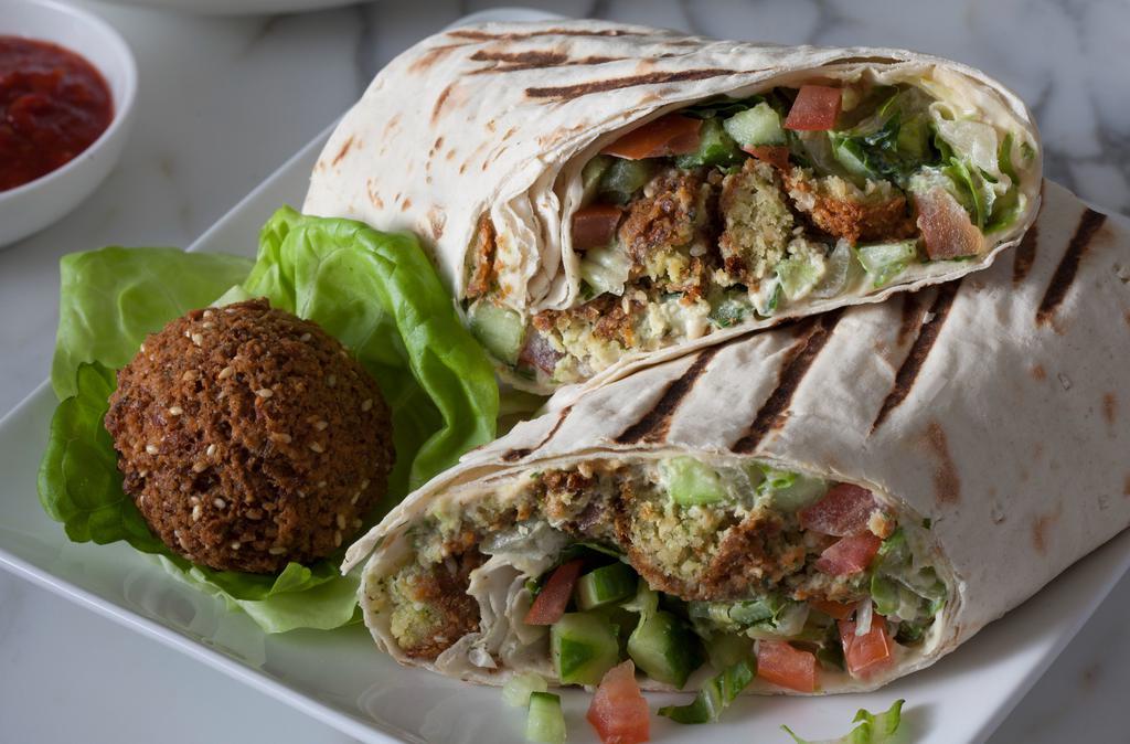 Falafel (Vegan) · Vegan. Fried chickpea patties with hummus and mediterranean salad topped with tahini wrapped in a lavash.