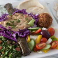 Mezza Plate · A medley of our favorite salads and dips topped with falafels and pita.