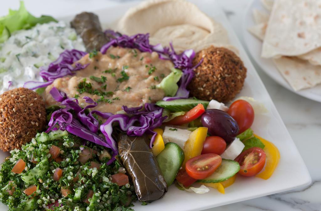 Mezza Plate · A medley of our favorite salads and dips topped with falafels and pita.