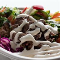 Beef Shawarma Bowl · Our Marinated steak shwarma with rice pilaf, red cabbage and choice of hummus or cucumber yo...
