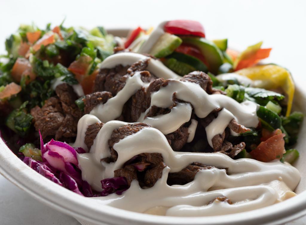 Beef Shawarma Bowl · Our Marinated steak shwarma with rice pilaf, red cabbage and choice of hummus or cucumber yogurt.