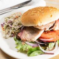 Smoked Pork Sandwich · Pork shoulder, seasoned with our rubbing spices and slow smoked for 10 hours. Served on a bu...