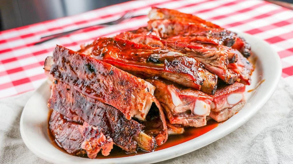 Slab of Ribs · This is not your small individual portion; this portion feeds three-four people. When we say a slab, we mean the whole slab of pork ribs. Add three side orders and corn bread.