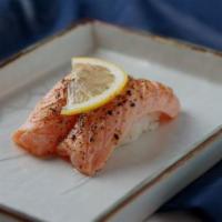 Seared Salmon (2 Pcs) · Seared salmon with lemon on top.
