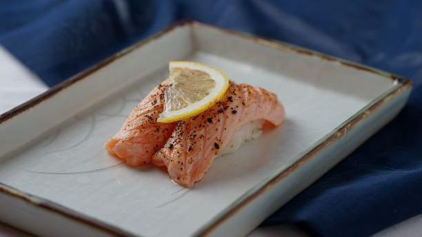 Seared Salmon (2 Pcs) · Seared salmon with lemon on top.