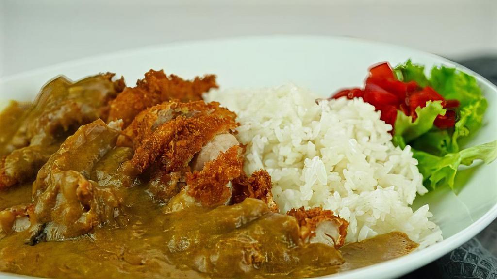Katsu Curry · Curry sauce over rice with pork cutlet.
