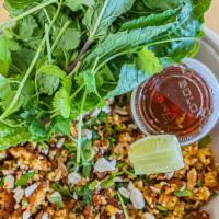 Nam Khao / Fried Rice Ball Salad · A Lao dish consisting of fried rice balls and herbs served on a bed of lettuce, topped with ...
