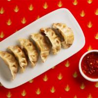 Spicy Potstickers · Pan fried pork filled dumplings with a house soy sauce.