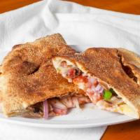 Vegetarian Calzone · Sauce, cheese, red onions, bell peppers, mushrooms, black olives.