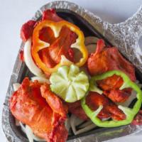 Tandoori Chicken · Chicken marinated in yogurt, blend of colorful Indian herbs and spices cooked in a clay oven.