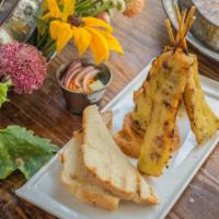 Gai Satay · Grilled marinated chicken skewers served with peanut sauce and cucumber relish